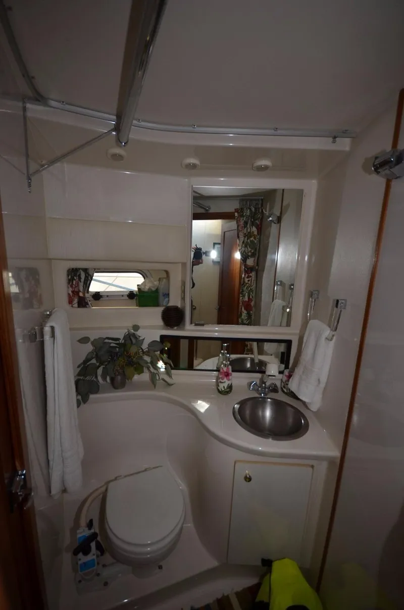 Slide: The Image of 1998 Bayliner 3988 yacht bathroom with sink and toilet. - 14
