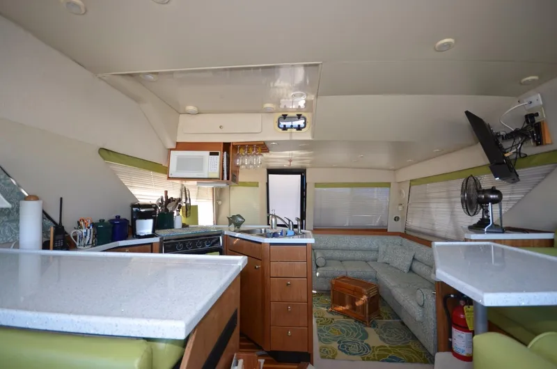 Slide: The Image of Interior of 1998 Bayliner 3988 Motoryacht with kitchen and seating area. - 17