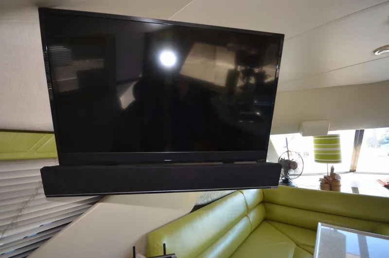Slide: The Image of Interior of Bayliner 3988 with TV and green sofa. - 23