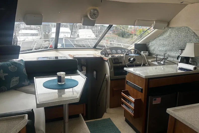 Slide: The Image of Interior of a 1998 Bayliner 3988 Command Bridge Motoryacht with helm, seating, and kitchenette. - 31