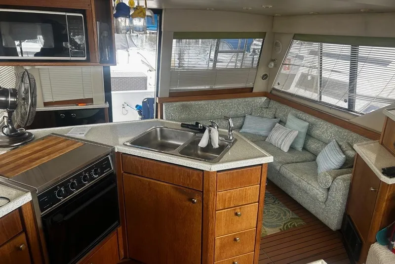 Slide: The Image of Interior of 1998 Bayliner 3988 Command Bridge Motoryacht with kitchen and seating area. - 32