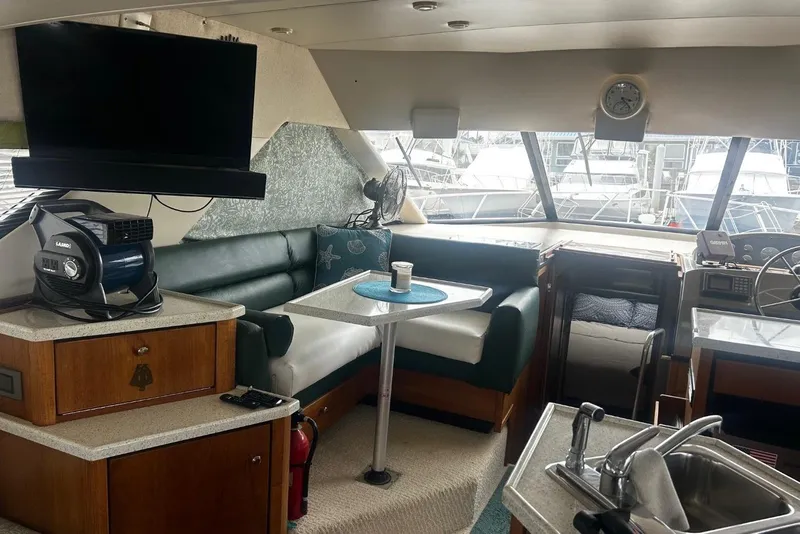 Slide: The Image of Interior of a 1998 Bayliner 3988 Command Bridge Motoryacht with seating, table, and helm. - 33