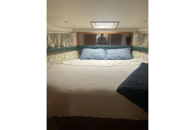 Slide: The Image of Cozy bedroom in 1998 Bayliner 3988 Command Bridge Motoryacht with blue accents. - 35