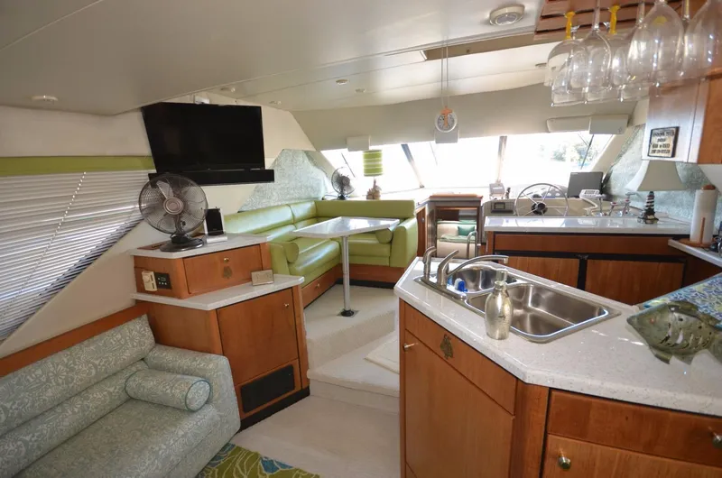 Slide: The Image of Interior of 1998 Bayliner 3988 Motoryacht with kitchen and seating area. - 6