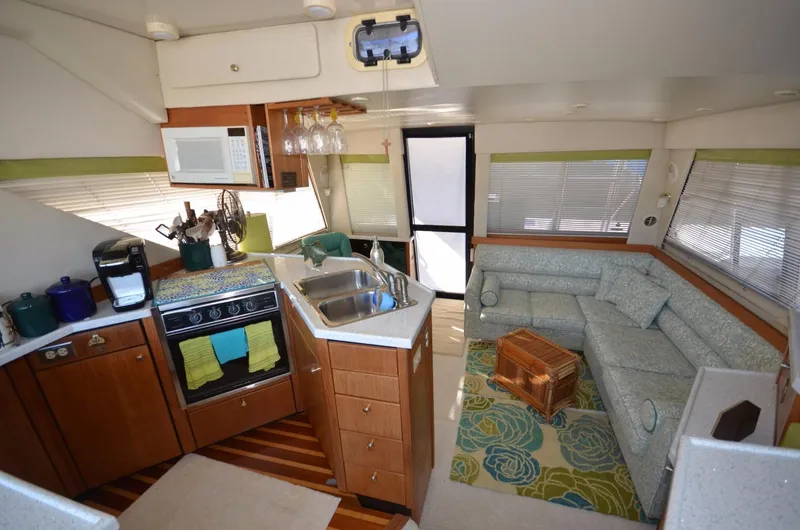 Slide: The Image of Interior of 1998 Bayliner 3988 Motoryacht, featuring kitchen and living area. - 9