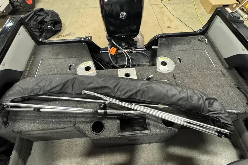 Slide: The Image of 2020 Crestliner 1850 Super Hawk boat interior with motor and folded canopy. - 12