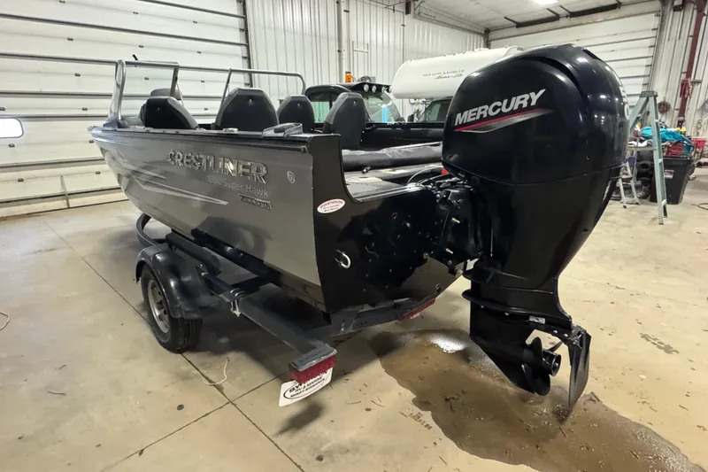 Slide: The Image of 2020 Crestliner 1850 Super Hawk boat with Mercury outboard motor in a garage. - 5