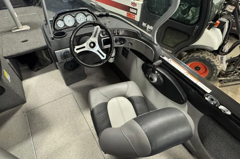 Slide: The Image of 2020 Crestliner 1850 Super Hawk boat interior with steering wheel and dashboard controls. - 6