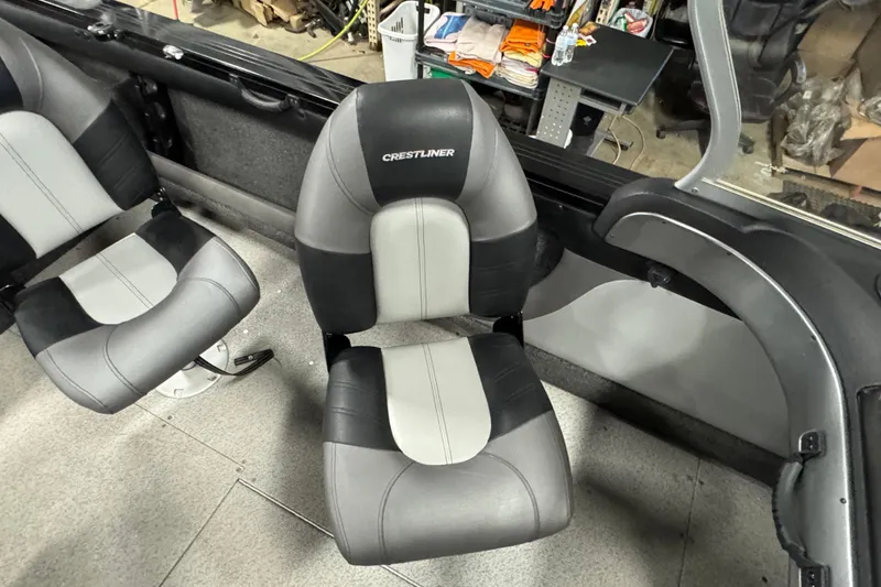 Slide: The Image of 2020 Crestliner 1850 Super Hawk interior with two-tone seats in a workshop setting. - 9