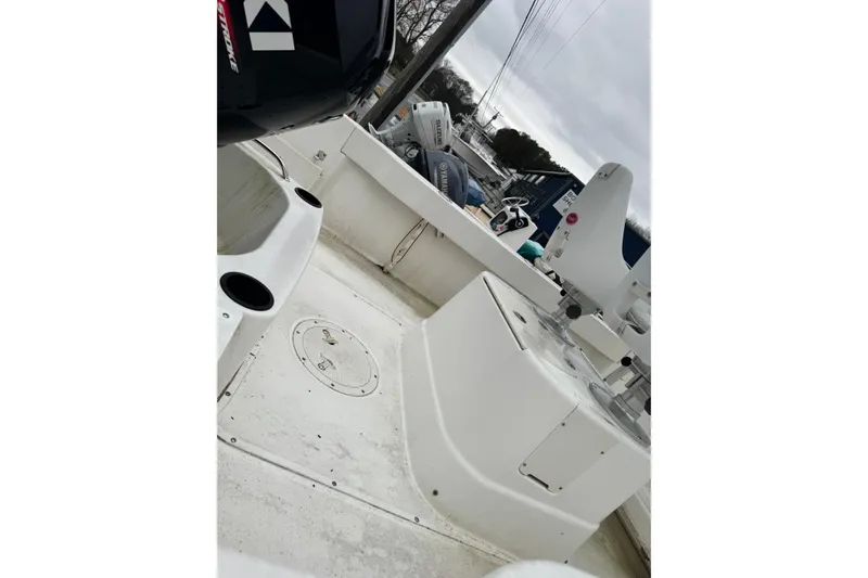Slide: The Image of 2005 Boston Whaler 190 Nantucket boat interior with motor and seating area. - 10