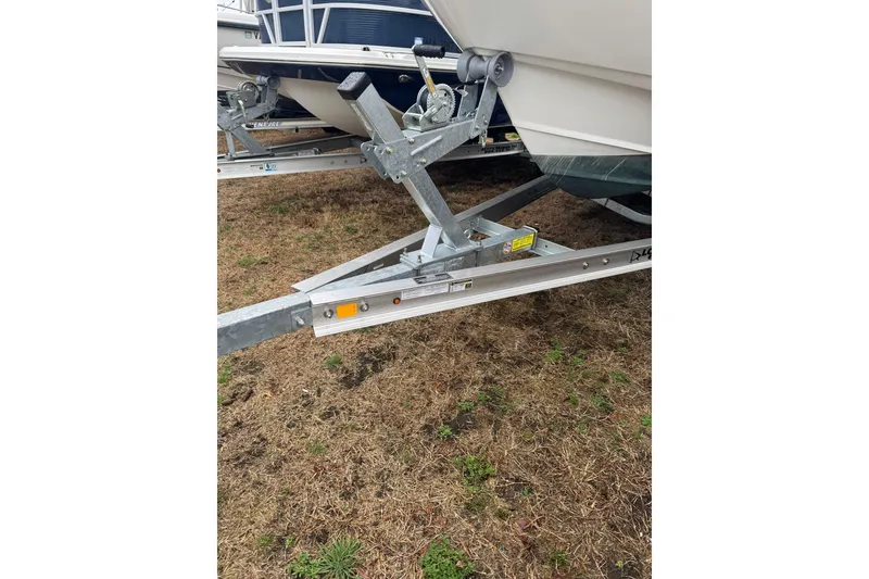 Slide: The Image of Trailer hitch of a 2005 Boston Whaler 190 Nantucket boat on grass. - 13