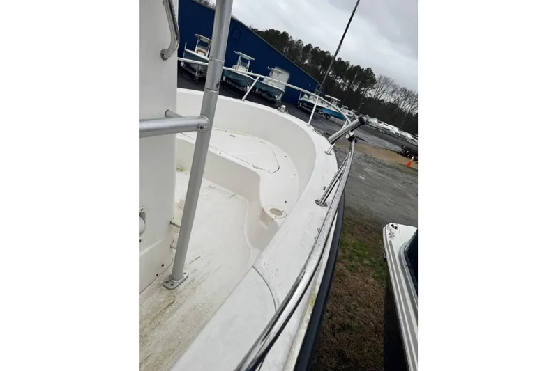 Slide: The Image of 2005 Boston Whaler 190 Nantucket boat deck with railing, parked outdoors. - 3