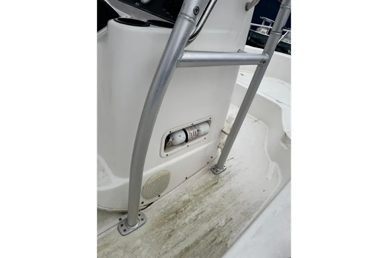 Slide: The Image of 2005 Boston Whaler 190 Nantucket boat interior with metal railing and storage compartment. - 5