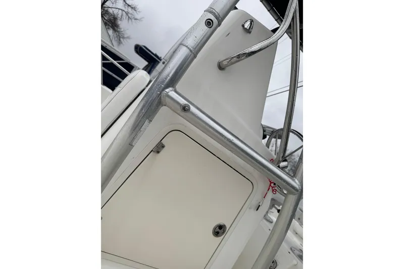 Slide: The Image of 2005 Boston Whaler 190 Nantucket boat console with metal railing detail. - 6