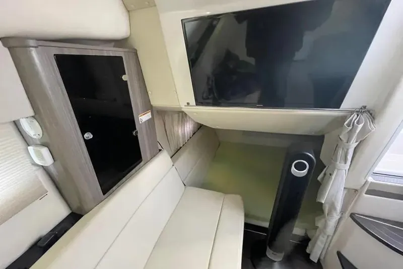 Slide: The Image of 2020 Regal 35 Sport Coupe cruising on calm waters near a marina. - 10