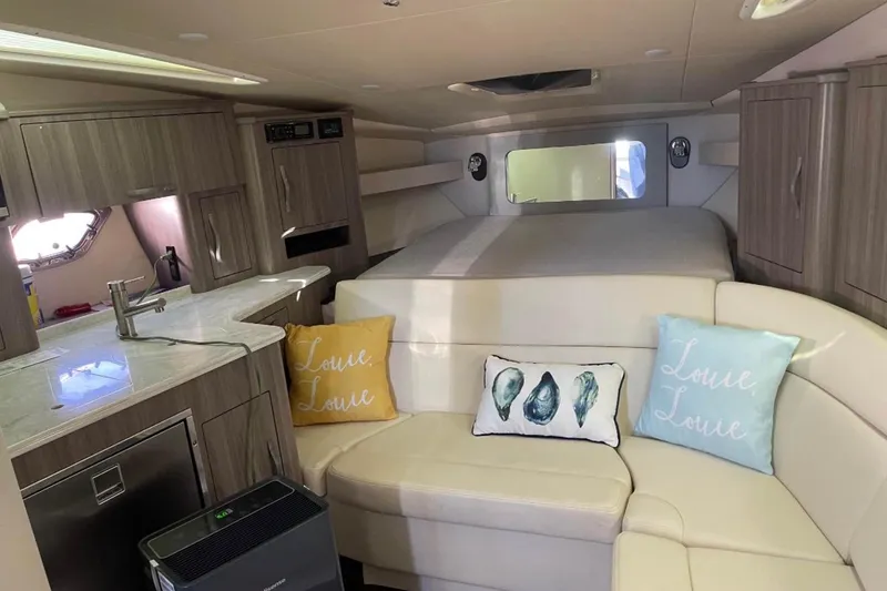 Slide: The Image of 2020 Regal 35 Sport Coupe boat with white seating and water reflections. - 11