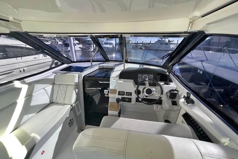 Slide: The Image of Open storage compartment on 2020 Regal 35 Sport Coupe boat with ropes and equipment. - 13