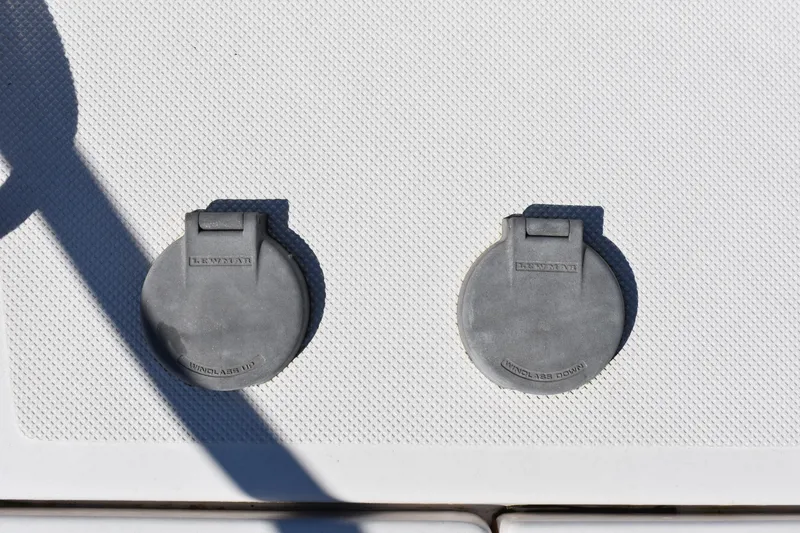Slide: The Image of Two Lewmar windlass control covers on a 2020 Regal 35 Sport Coupe boat deck. - 17