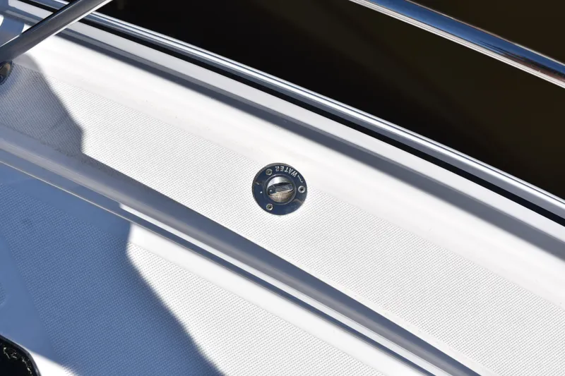 Slide: The Image of Fuel cap on 2020 Regal 35 Sport Coupe boat deck, featuring stainless steel railing. - 18