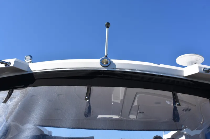 Slide: The Image of 2020 Regal 35 Sport Coupe boat windshield against clear blue sky. - 23