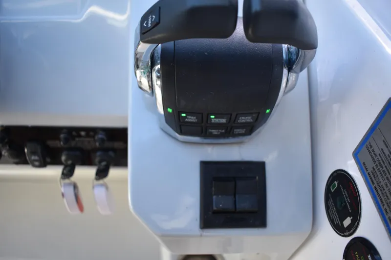Slide: The Image of Control panel of a 2020 Regal 35 Sport Coupe boat, featuring throttle and switches. - 32