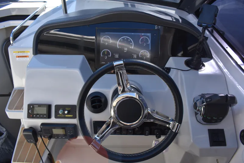 Slide: The Image of Cockpit of 2020 Regal 35 Sport Coupe with steering wheel and control panel. - 33