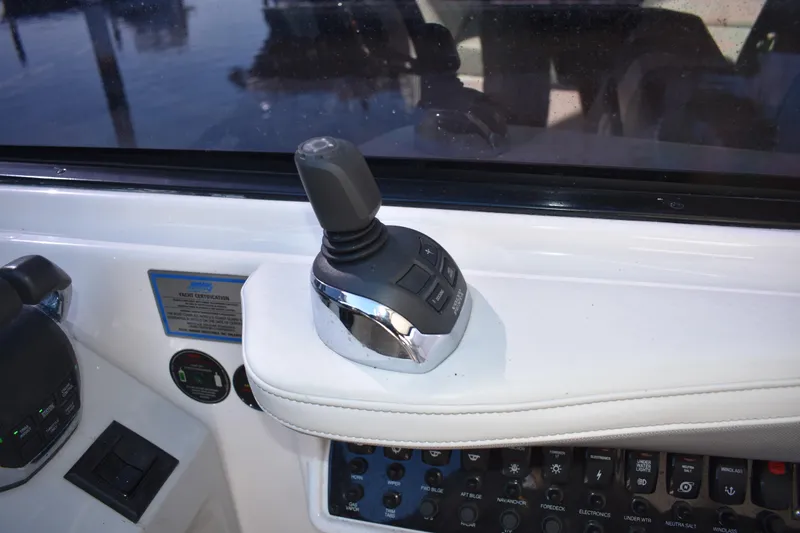 Slide: The Image of Control panel of a 2020 Regal 35 Sport Coupe boat with joystick and switches. - 35