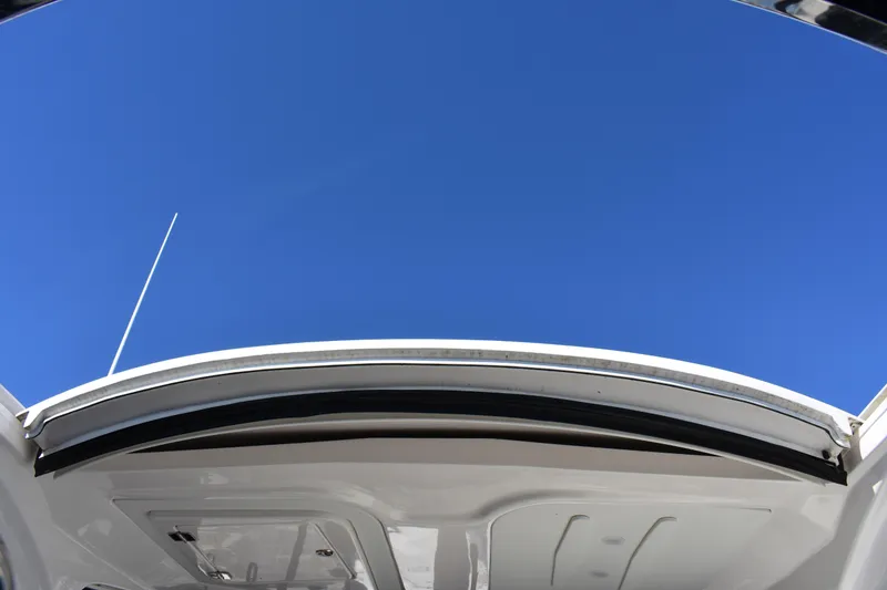 Slide: The Image of 2020 Regal 35 Sport Coupe sunroof open under clear blue sky. - 40