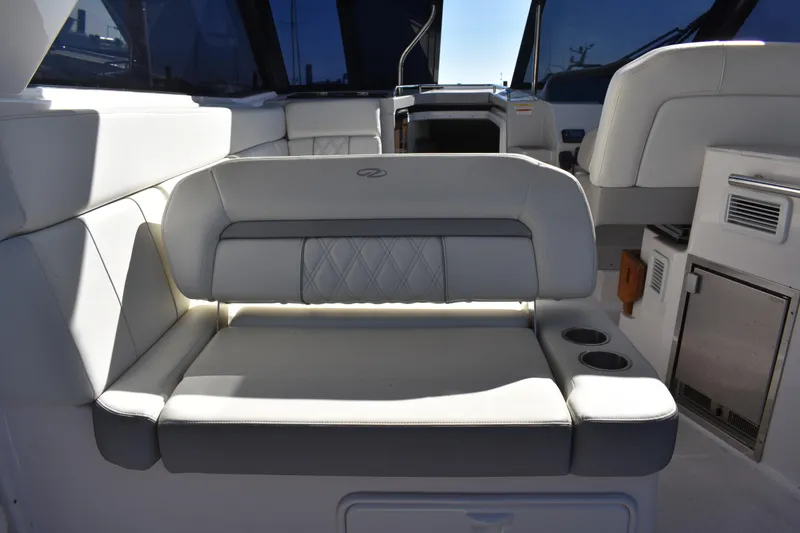 Slide: The Image of 2020 Regal 35 Sport Coupe interior with white leather seating and cup holders. - 43