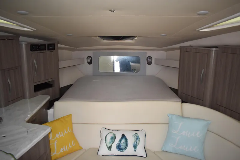 Slide: The Image of Interior of 2020 Regal 35 Sport Coupe with cozy bed and decorative pillows. - 48