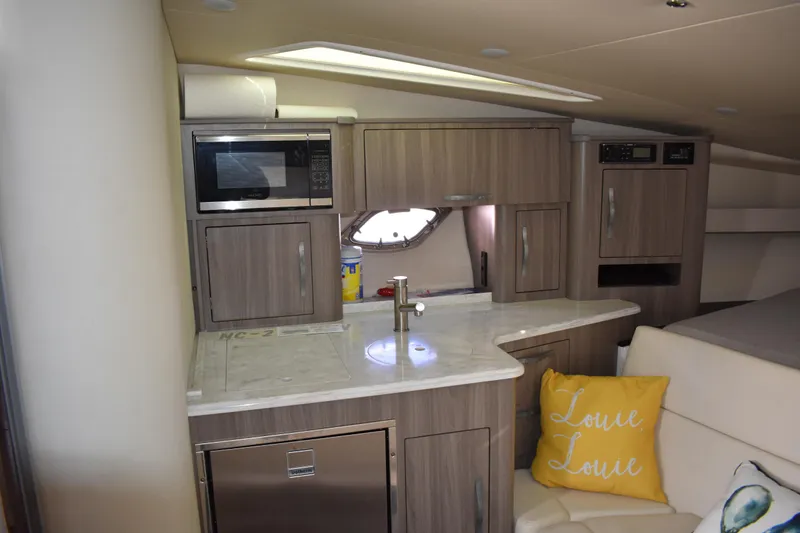 Slide: The Image of 2020 Regal 35 Sport Coupe interior with kitchenette, microwave, and cozy seating area. - 51