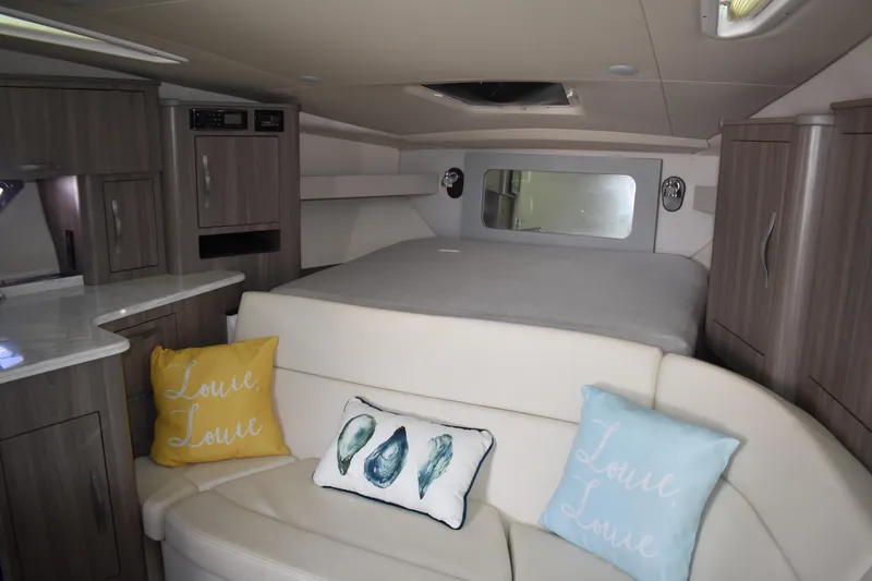 Slide: The Image of Interior of 2020 Regal 35 Sport Coupe with cozy seating and decorative pillows. - 52