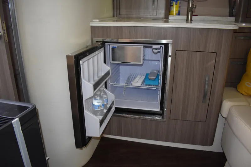 Slide: The Image of Compact refrigerator in 2020 Regal 35 Sport Coupe yacht interior, open with water bottles. - 53