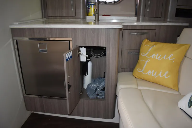 Slide: The Image of Interior of 2020 Regal 35 Sport Coupe with open cabinet and yellow pillow. - 54