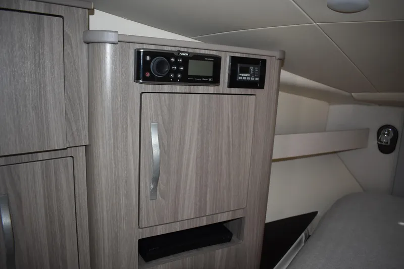 Slide: The Image of 2020 Regal 35 Sport Coupe interior with wood cabinetry and control panel. - 56