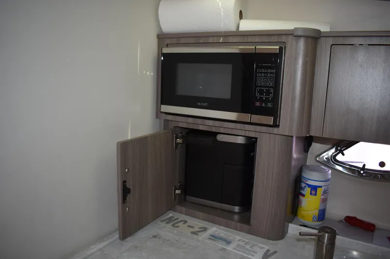 Slide: The Image of 2020 Regal 35 Sport Coupe interior kitchen with microwave and storage cabinet. - 59