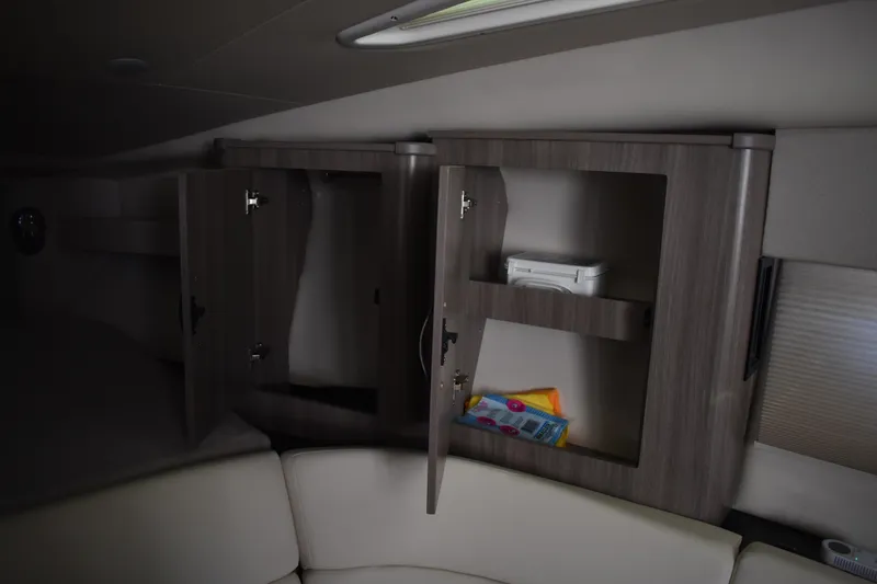 Slide: The Image of Interior storage cabinets in 2020 Regal 35 Sport Coupe boat, featuring open shelving. - 64