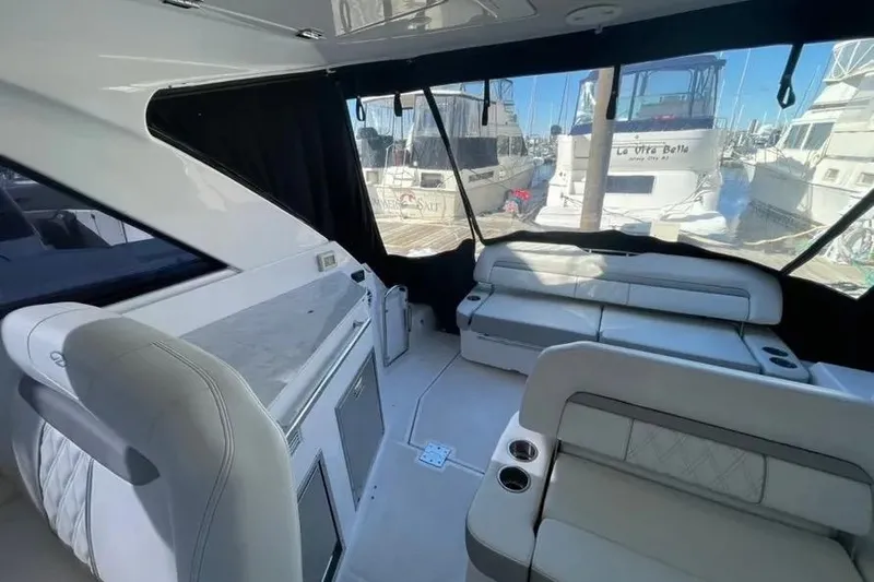 Slide: The Image of 2020 Regal 35 Sport Coupe boat on water, rear view with two people onboard. - 7