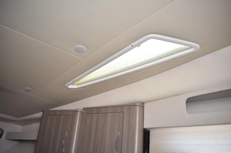 Slide: The Image of Interior ceiling of 2020 Regal 35 Sport Coupe with skylight and cabinets. - 73
