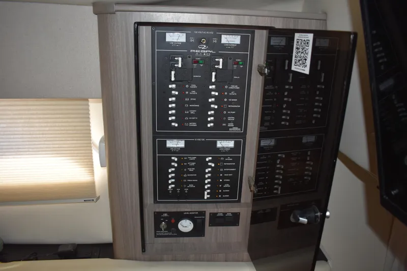 Slide: The Image of Electrical control panel inside a 2020 Regal 35 Sport Coupe boat cabin. - 76