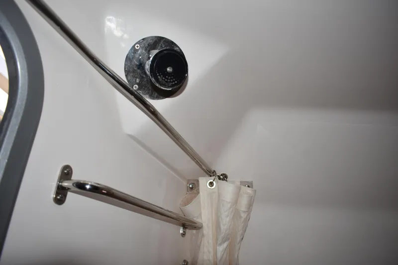 Slide: The Image of Interior detail of a 2020 Regal 35 Sport Coupe, featuring a shower curtain and chrome fixtures. - 83