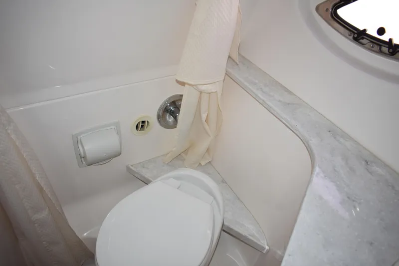 Slide: The Image of 2020 Regal 35 Sport Coupe bathroom with toilet, marble countertop, and porthole window. - 84