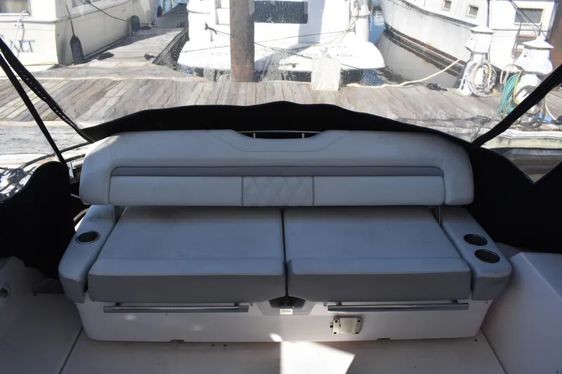 Slide: The Image of 2020 Regal 35 Sport Coupe interior seating with cup holders, docked at marina. - 85