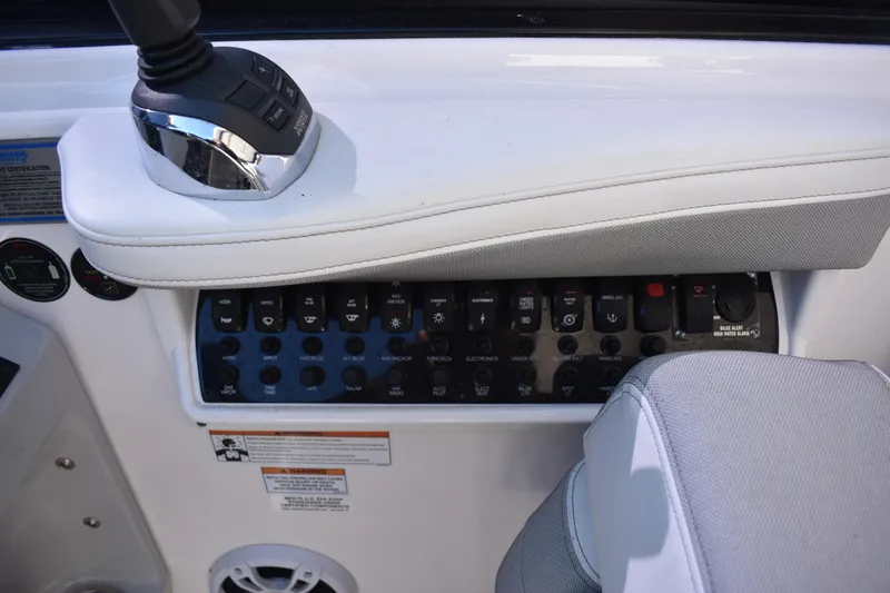 Slide: The Image of Control panel of a 2020 Regal 35 Sport Coupe boat with various switches and controls. - 88