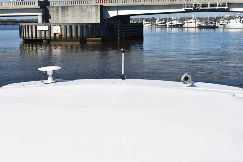 Slide: The Image of Bow view of 2020 Regal 35 Sport Coupe approaching a bridge on calm water. - 92