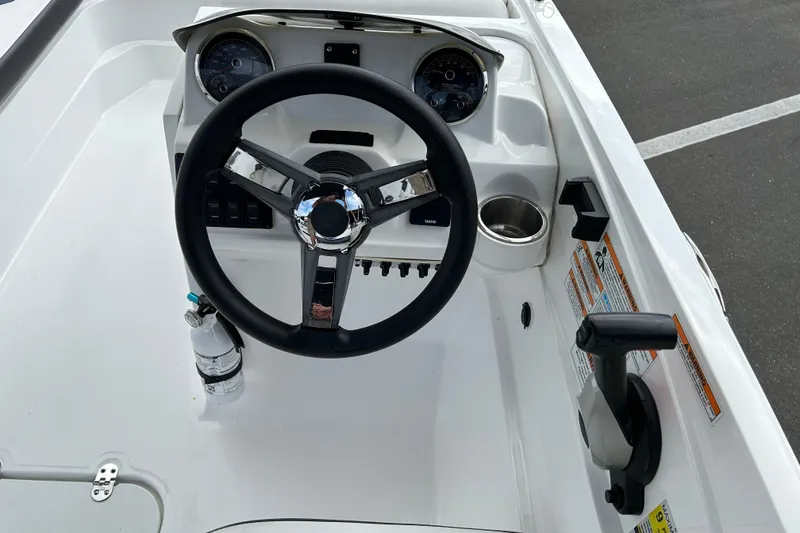 Slide: The Image of 2022 Hurricane SunDeck Sport 185 OB boat dashboard with steering wheel and controls. - 11