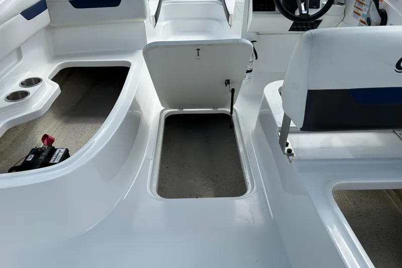 Slide: The Image of 2022 Hurricane SunDeck Sport 185 OB interior with storage compartment and seating. - 17