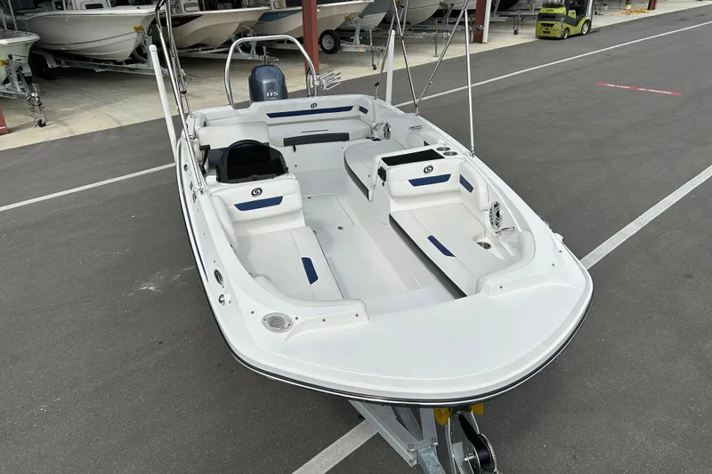 Slide: The Image of 2022 Hurricane SunDeck Sport 185 OB boat in a showroom, showcasing sleek design and spacious seating. - 6