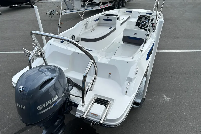 Slide: The Image of 2022 Hurricane SunDeck Sport 185 OB boat with Yamaha 115 engine, parked on asphalt. - 7