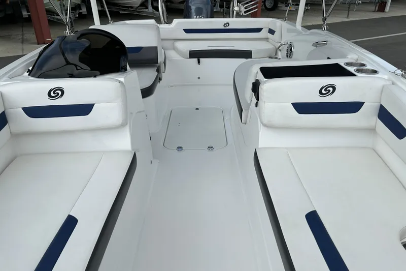 Slide: The Image of 2022 Hurricane SunDeck Sport 185 OB interior with white and blue seating, spacious layout. - 9